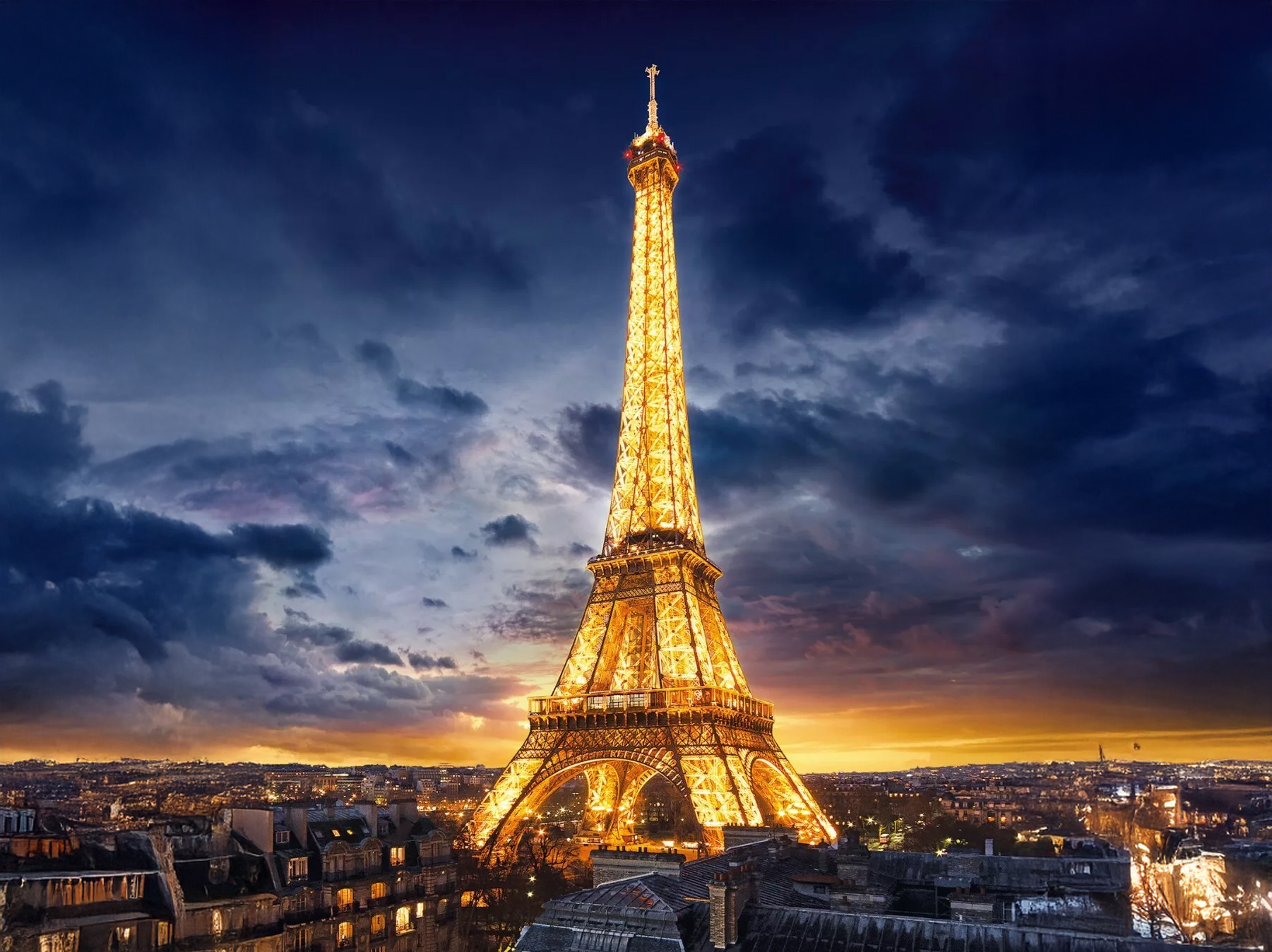 Eiffel Tower illuminated at night in Paris, symbolising iconic global destinations for executive travellers.