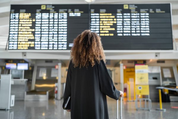 Liverpool airport transfers – passenger at departures board